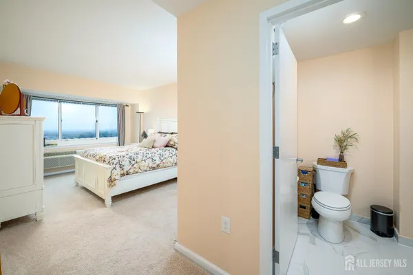 a bedroom with a bed and a potted plant