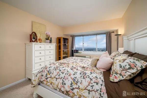 a bedroom with a large bed and a window