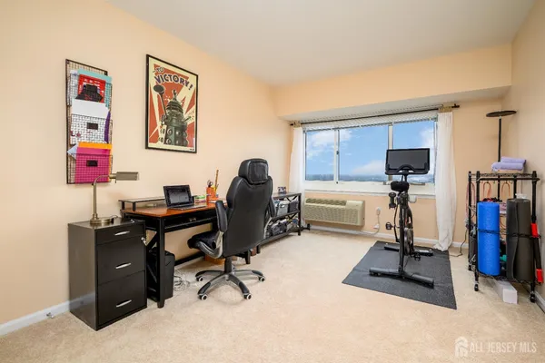 a view of a workspace with furniture and gym cycle