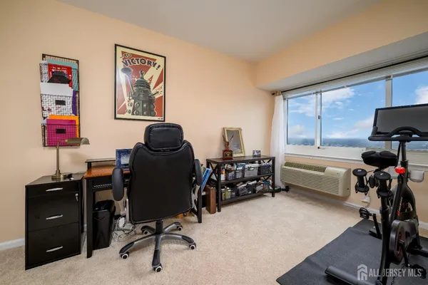 a view of a workspace with furniture and a window