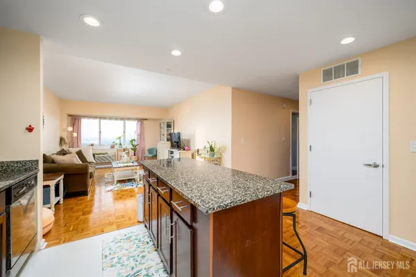 a living room with dining room and wooden floor