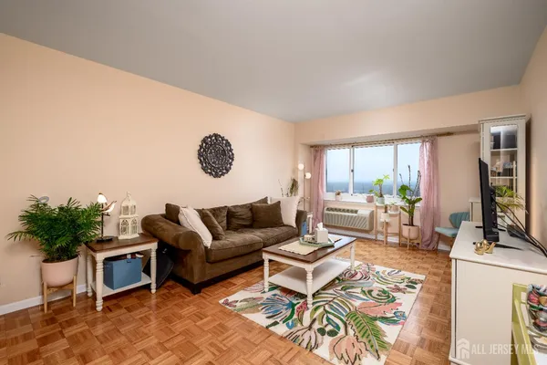 a living room with furniture wooden floor and a flat screen tv
