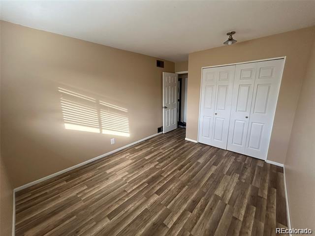 1225 South Oneida Street, Unit 252 Denver, CO 80224 - Photo 11 of 20 a view of empty room with wooden floor and fan