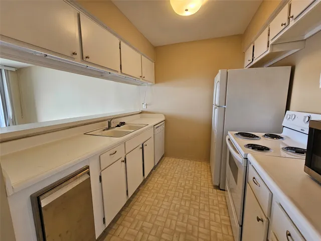 a utility room with cabinets washer and dryer