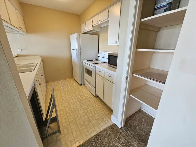 a kitchen with a refrigerator a washer and dryer