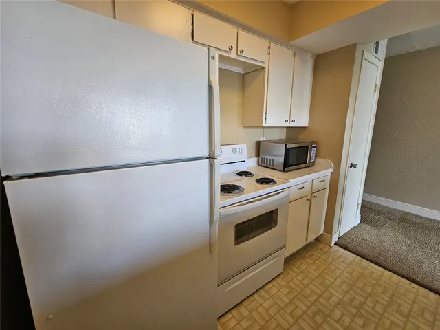 a kitchen with stainless steel appliances a refrigerator sink and cabinets