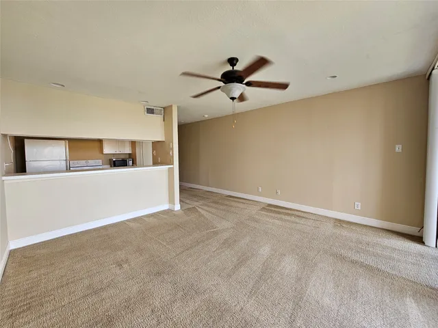 a view of a kitchen with a ceiling fan