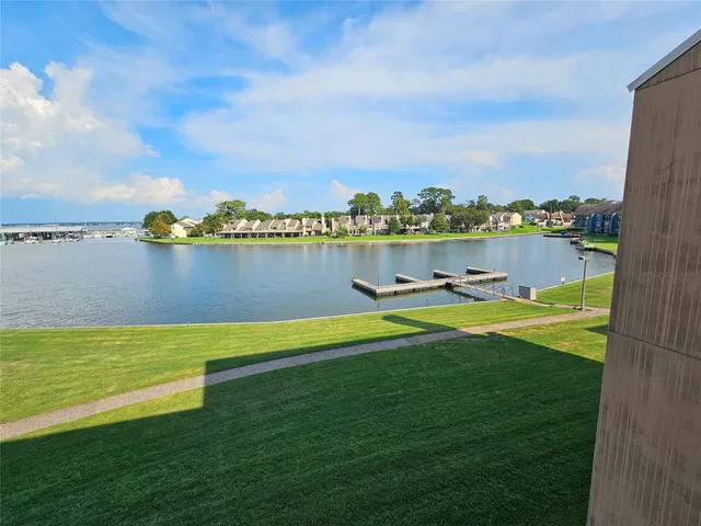 a view of a lake with houses in the back