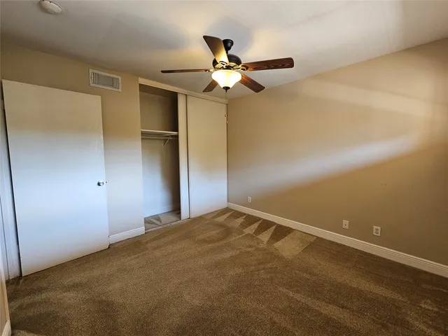 a view of a room with a ceiling fan