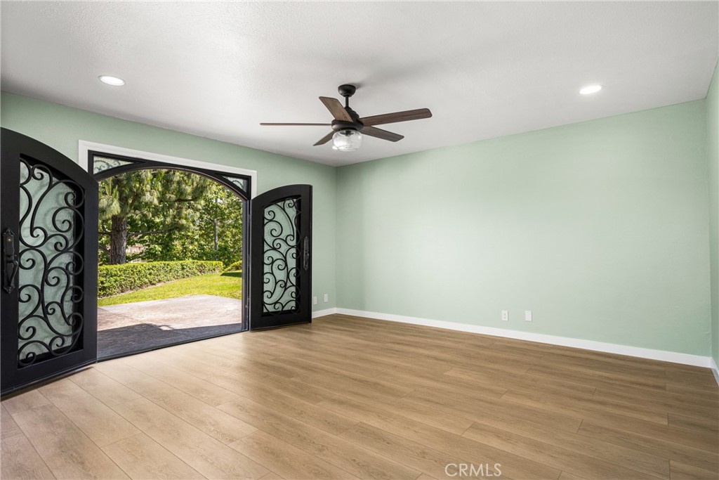 5554 East Vista Del Rio Anaheim, CA 92807 - Photo 13 of 42 an empty room with windows and ceiling fan