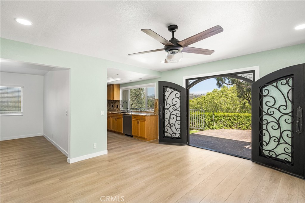 5554 East Vista Del Rio Anaheim, CA 92807 - Photo 15 of 42 a view of an empty room with a window and wooden floor