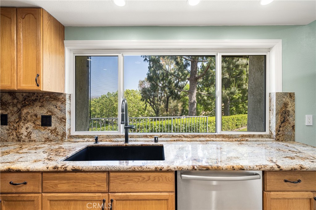 5554 East Vista Del Rio Anaheim, CA 92807 - Photo 19 of 42 a kitchen with granite countertop a sink and a window