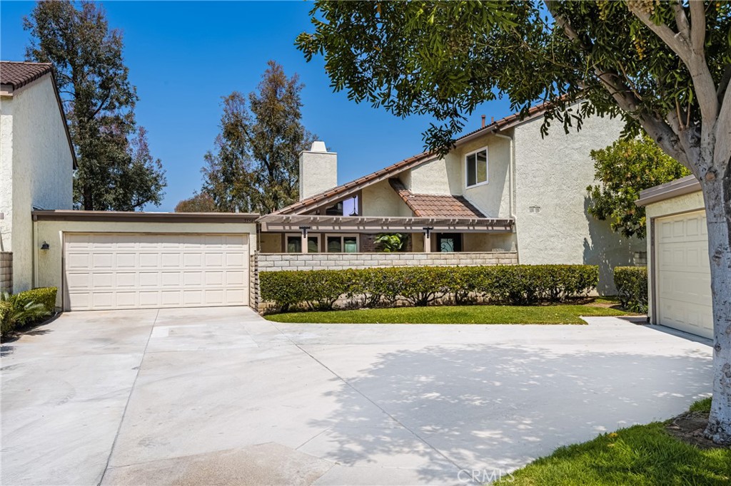 5554 East Vista Del Rio Anaheim, CA 92807 - Photo 2 of 42 a front view of a house with a yard and garage