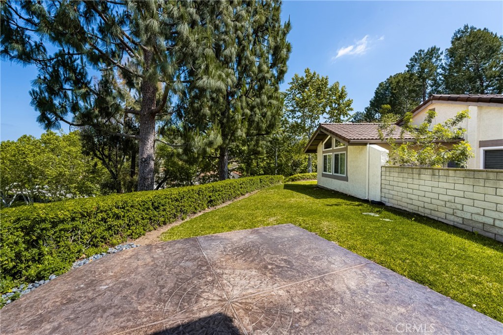 5554 East Vista Del Rio Anaheim, CA 92807 - Photo 21 of 42 a view of a backyard with plants and large trees