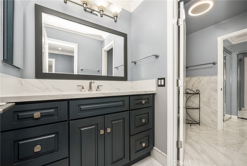 5554 East Vista Del Rio Anaheim, CA 92807 - Photo 29 of 42 a bathroom with a granite countertop sink vanity and a mirror