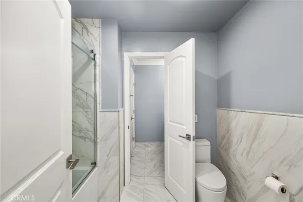 a bathroom with a shower and a toilet