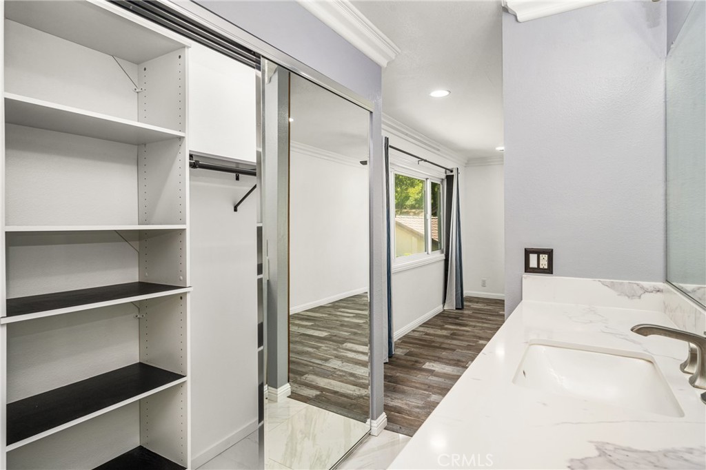 5554 East Vista Del Rio Anaheim, CA 92807 - Photo 36 of 42 a bedroom with a bed and walk in closet