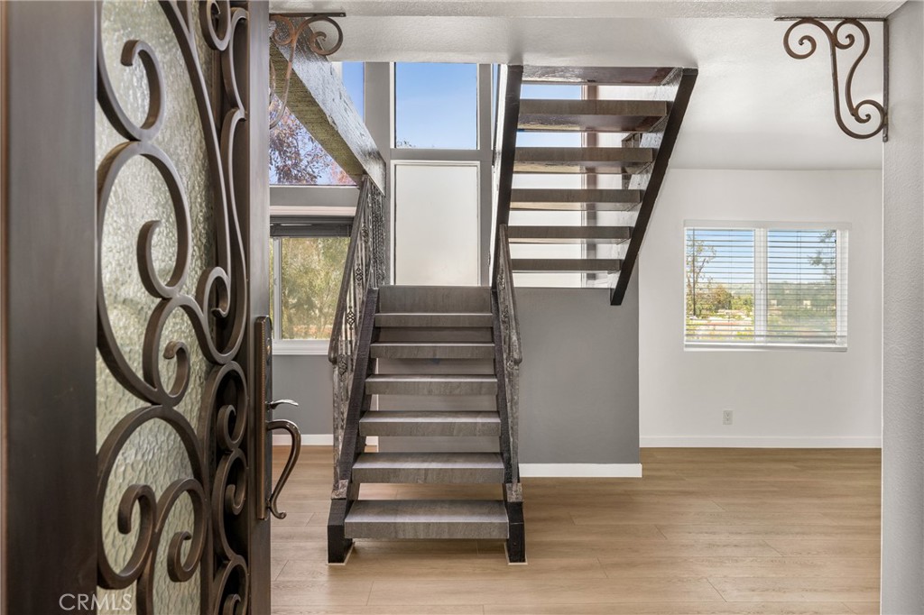 5554 East Vista Del Rio Anaheim, CA 92807 - Photo 7 of 42 a view of staircase with lots of frames on wall and a window