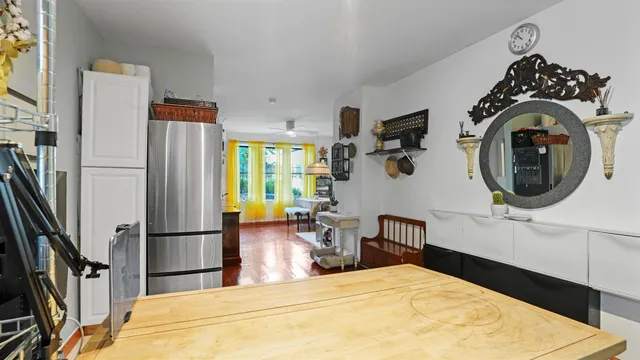 a bedroom with a bed and a refrigerator