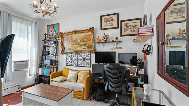 a living room with furniture a flat screen tv and a wall painting