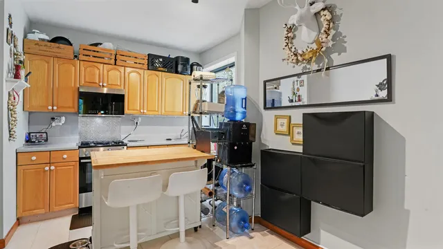 a kitchen with stainless steel appliances granite countertop a refrigerator and a stove top oven