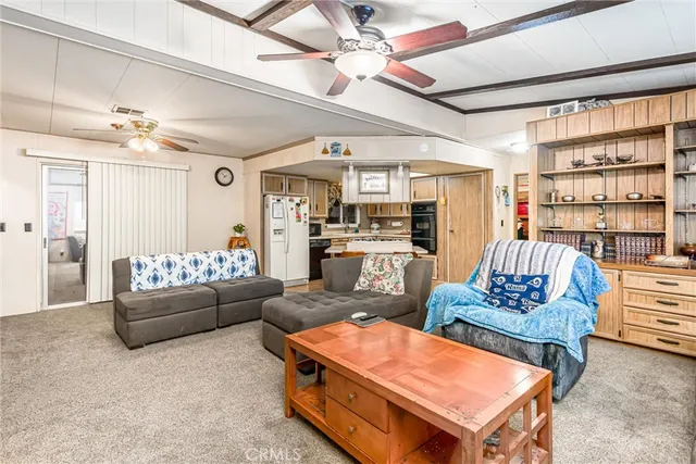 a living room with furniture and a book shelf