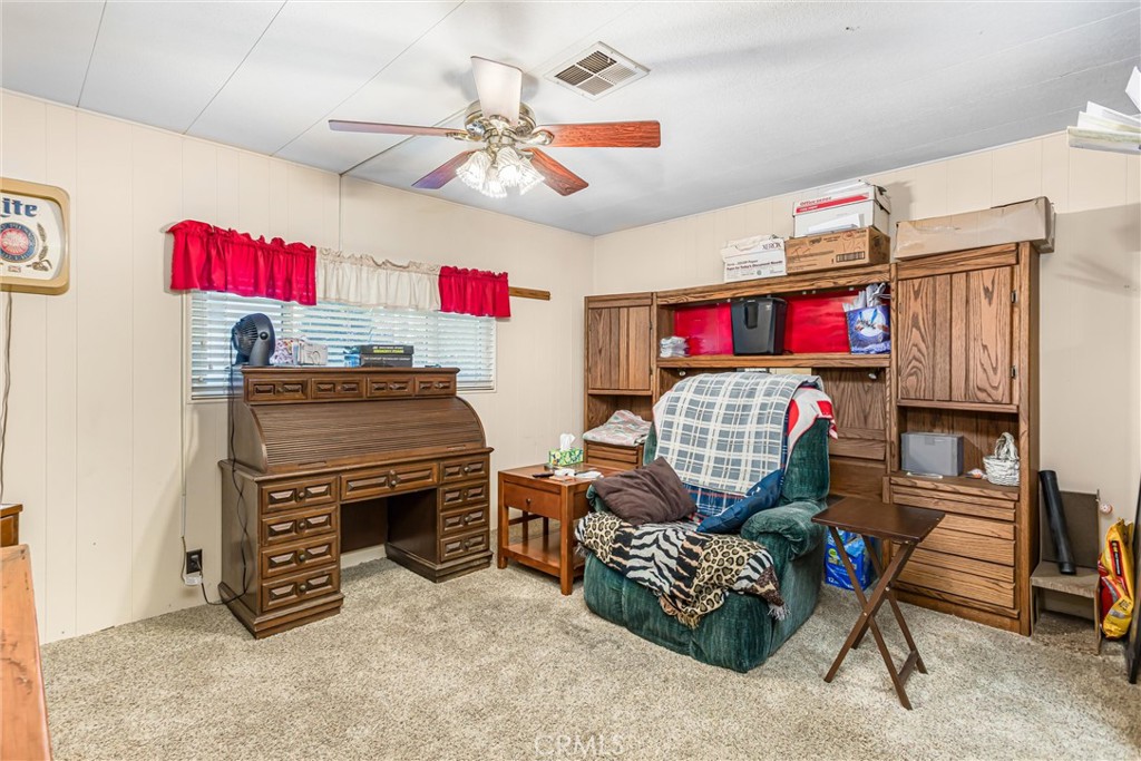 4000 Pierce Street, Unit 106 Riverside, CA 92505 - Photo 8 of 18 a living room with furniture and a flat screen tv
