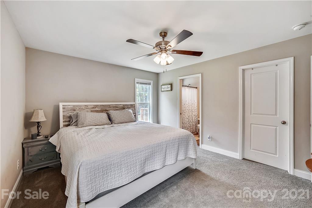 225 Stone Road Salisbury, NC 28146 - Photo 12 of 21 a bedroom with a bed and a chandelier