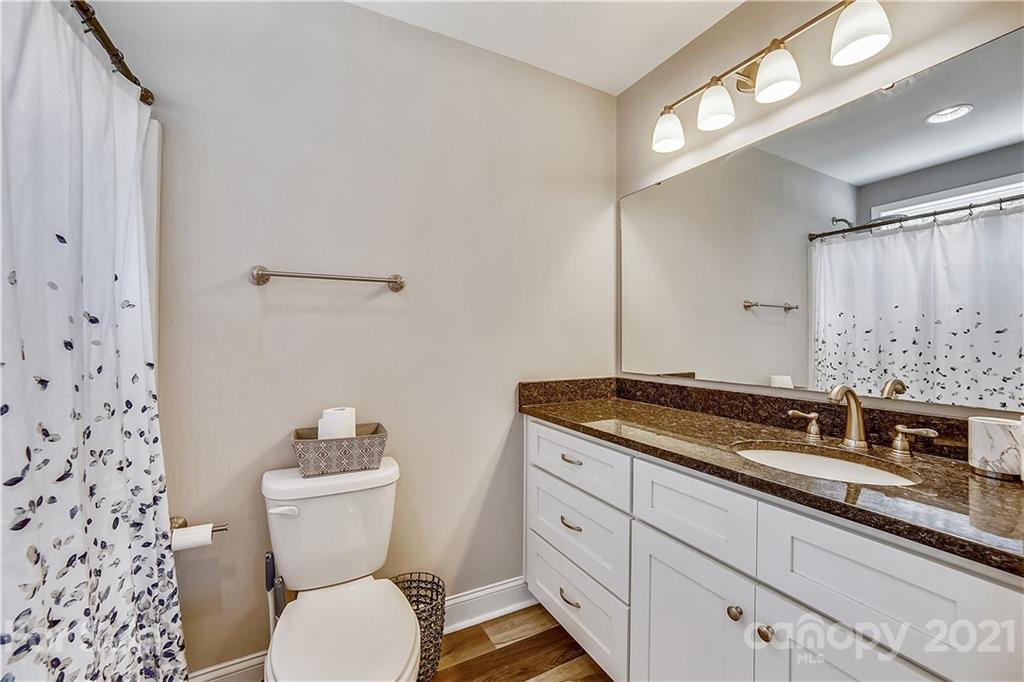 225 Stone Road Salisbury, NC 28146 - Photo 16 of 21 a bathroom with a granite countertop toilet sink and mirror