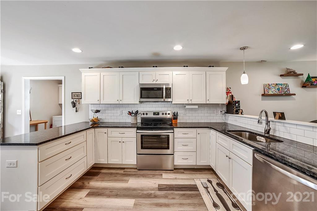 225 Stone Road Salisbury, NC 28146 - Photo 7 of 21 a kitchen with granite countertop white cabinets and stainless steel appliances