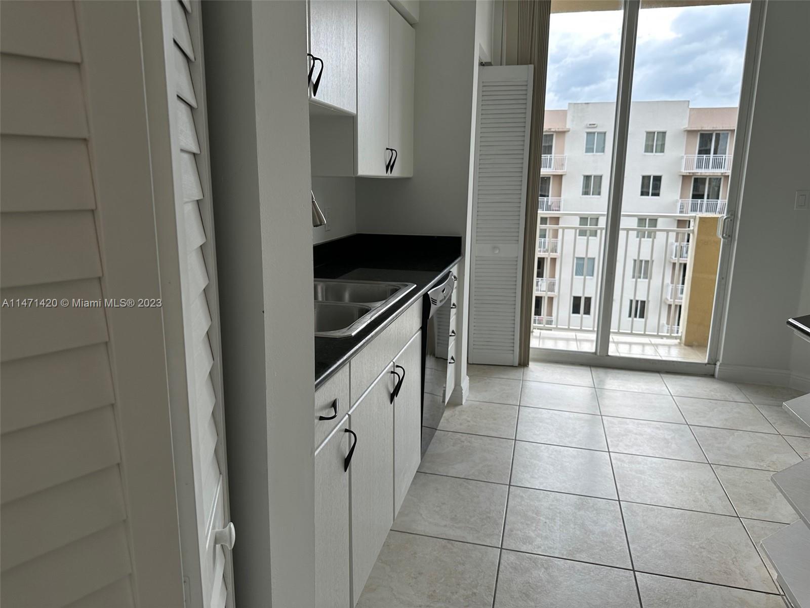 Silver Bluff Estates Miami, FL 33145 - Photo 14 of 27 a kitchen with granite countertop a sink and a refrigerator