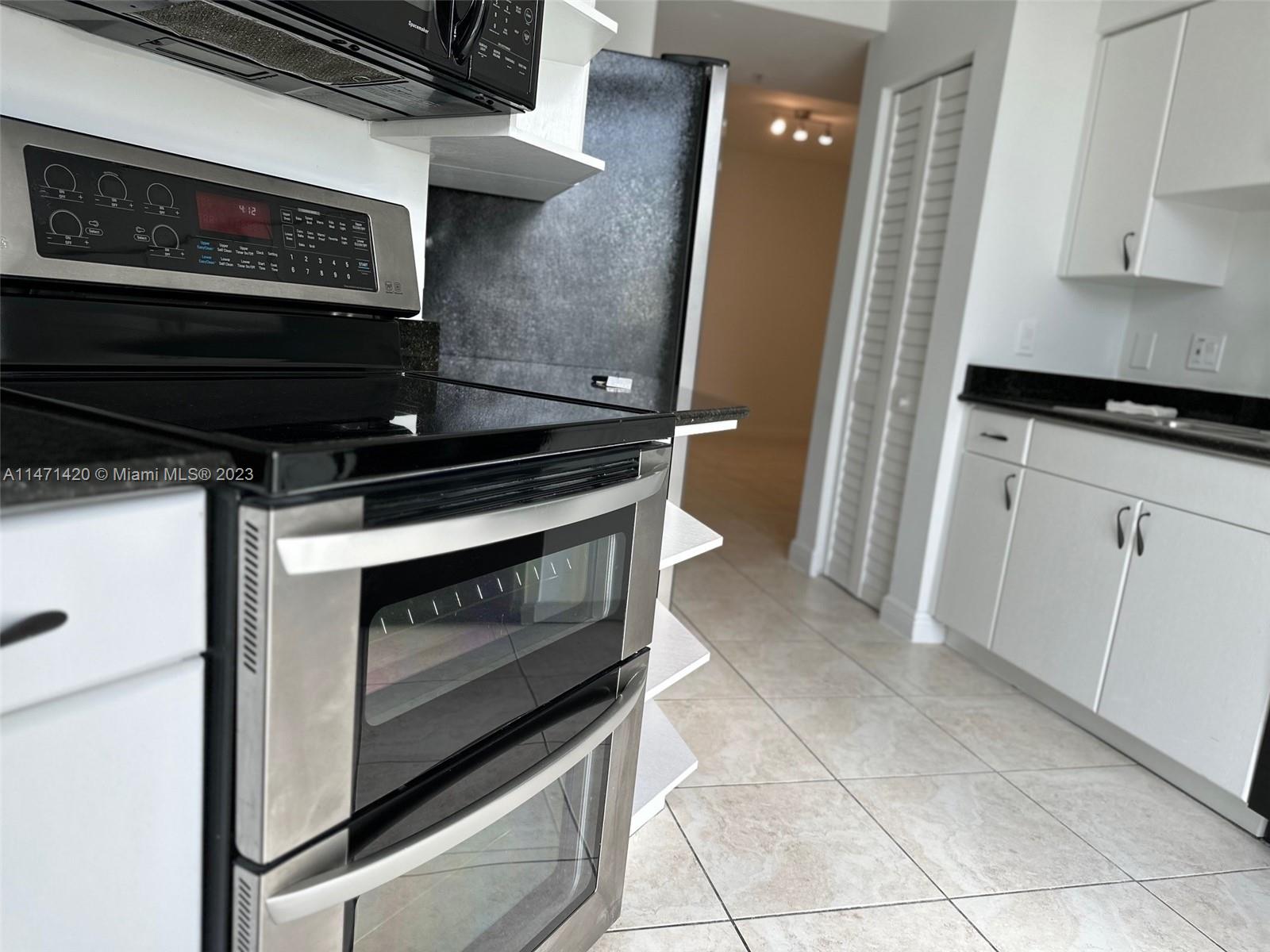 Silver Bluff Estates Miami, FL 33145 - Photo 16 of 27 a stove top oven sitting inside of a kitchen