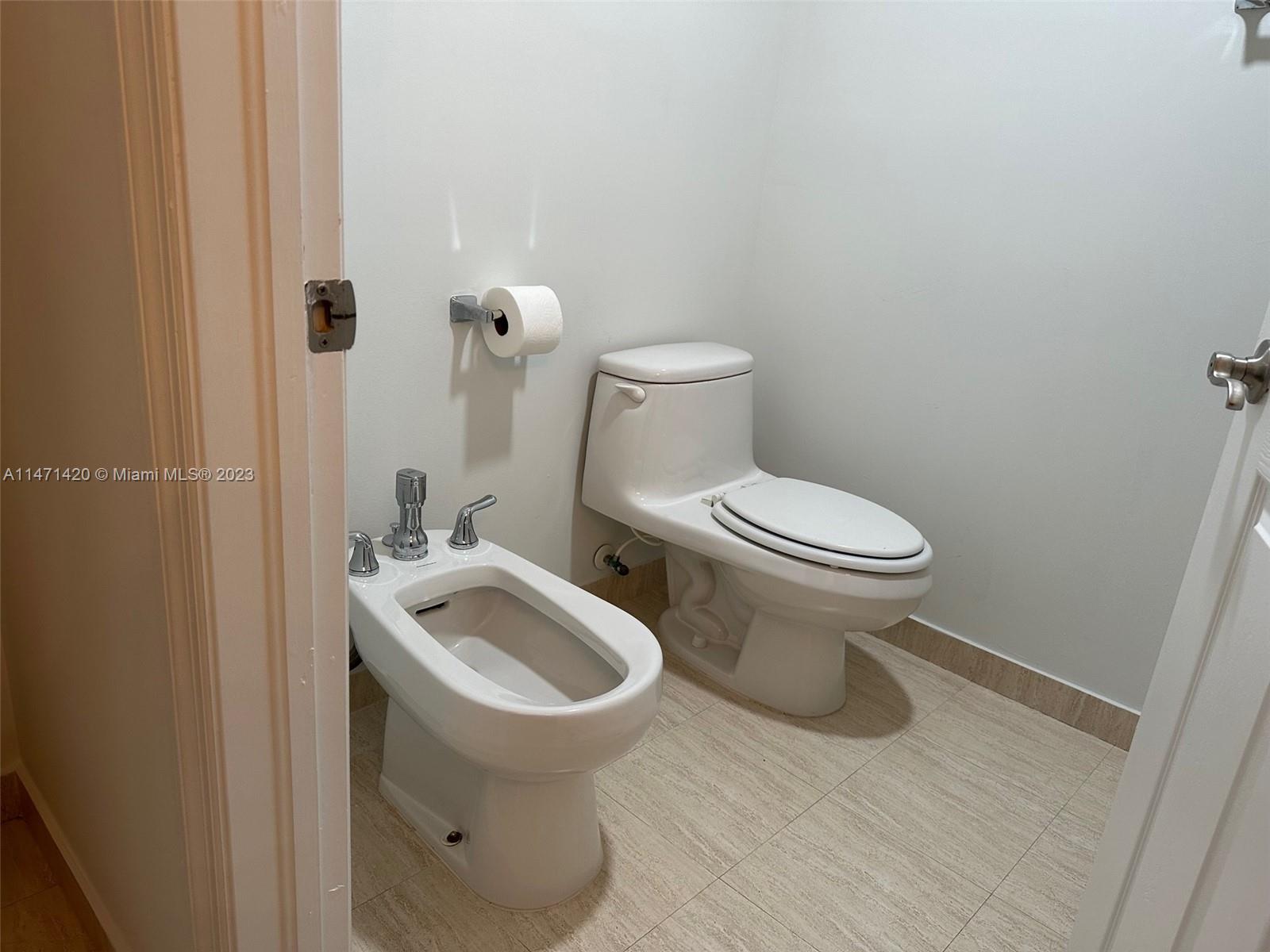 Silver Bluff Estates Miami, FL 33145 - Photo 21 of 27 a white toilet sitting next to a bathroom sink