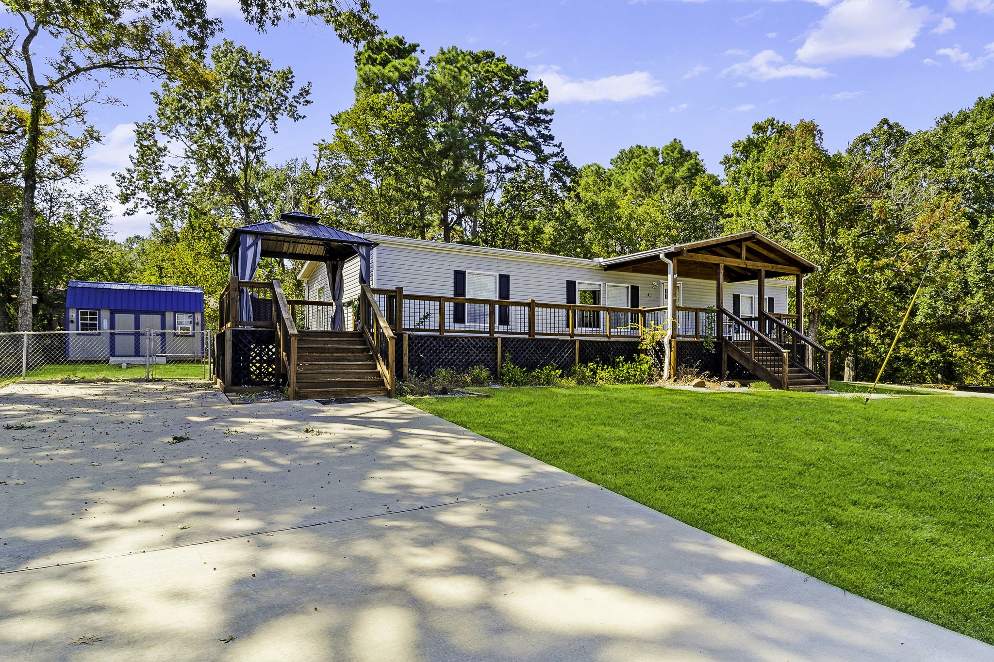 a view of a house with backyard and a tree