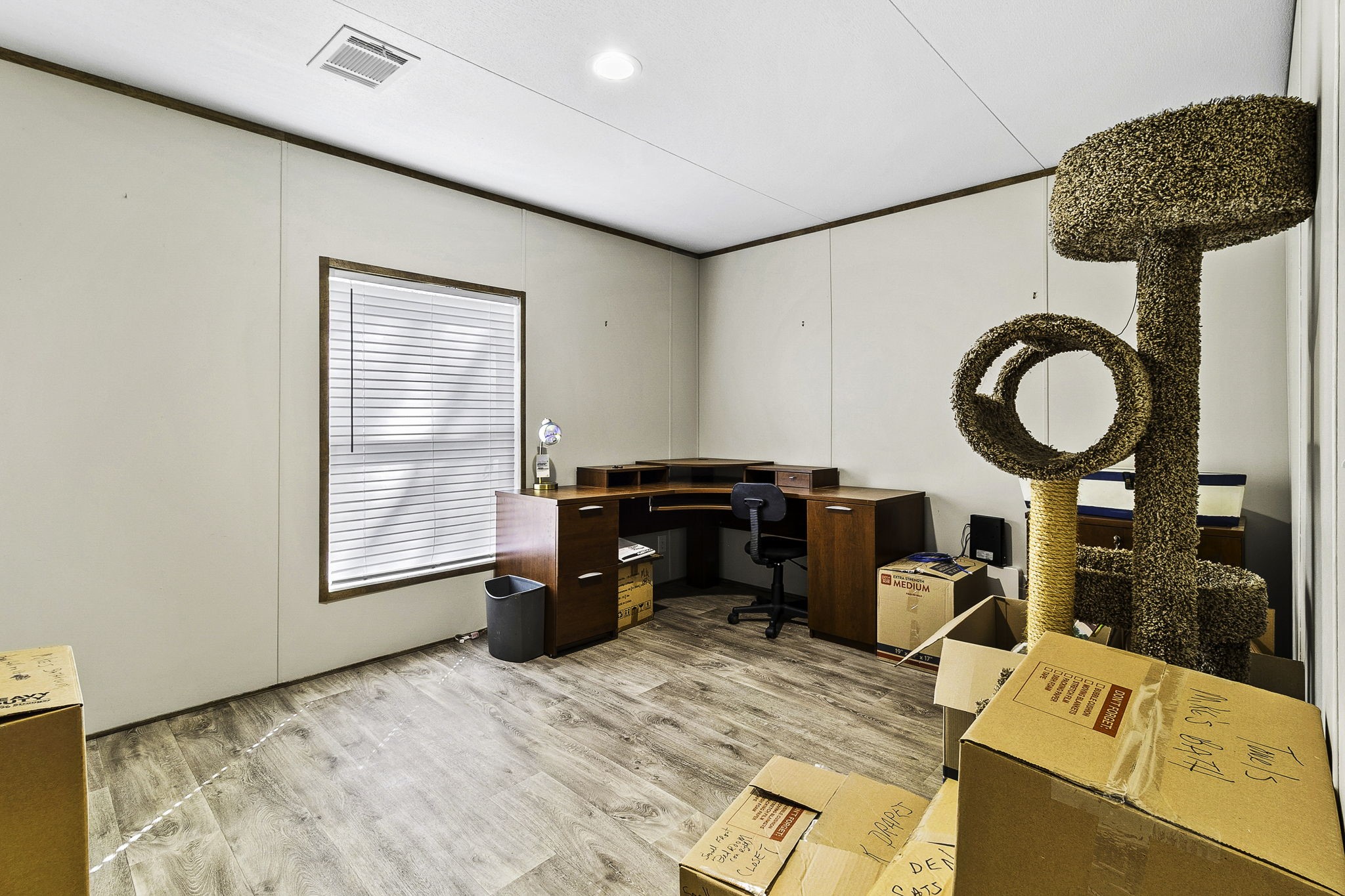 41 Ferguson Way Point Blank, TX 77364 - Photo 11 of 34 a bedroom with a bed and a chandelier