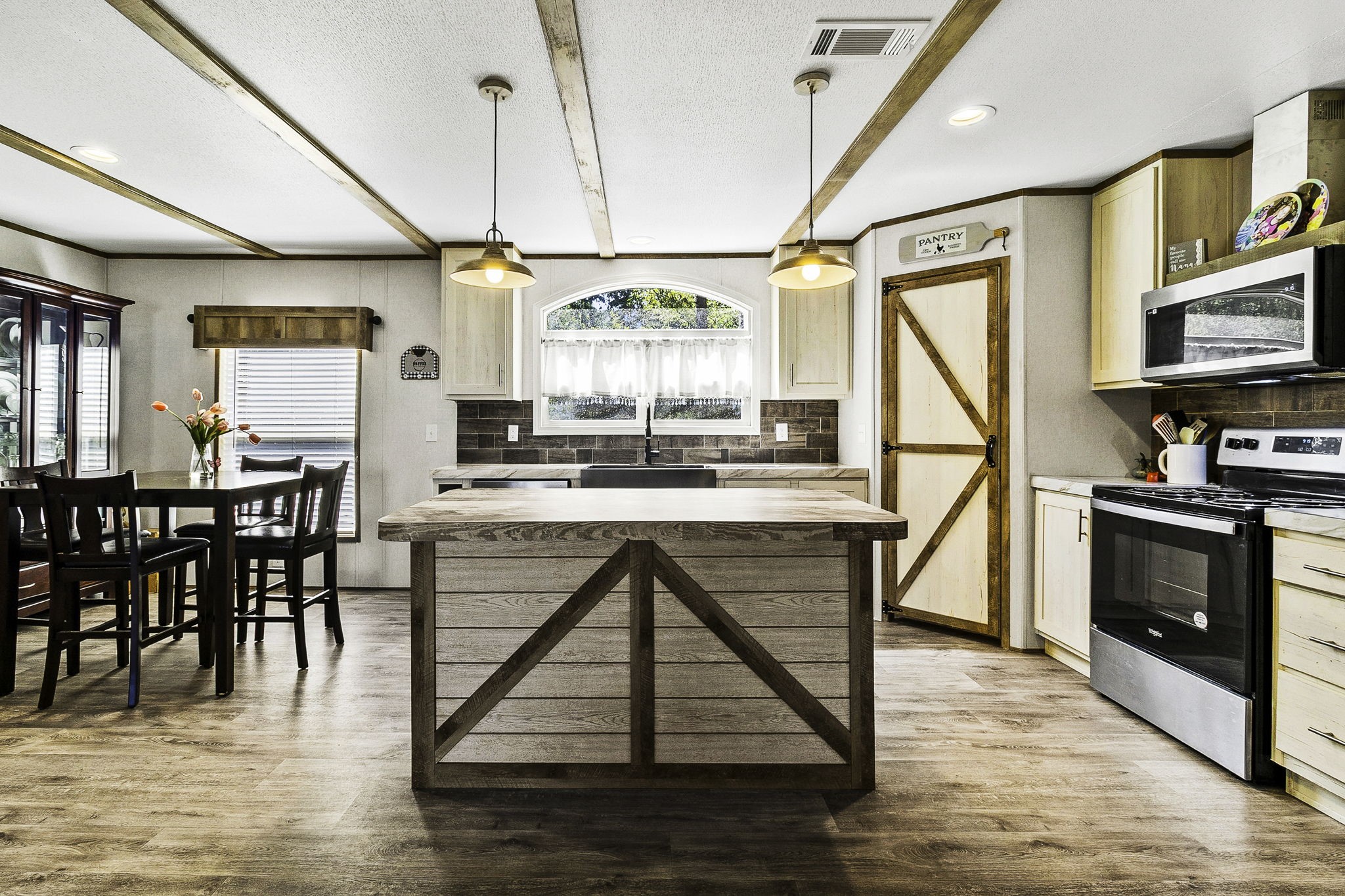 41 Ferguson Way Point Blank, TX 77364 - Photo 15 of 34 a kitchen with stainless steel appliances granite countertop a stove top oven a sink a dining table and chairs