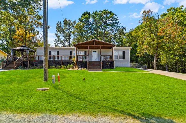 a view of a house with a yard and sitting area