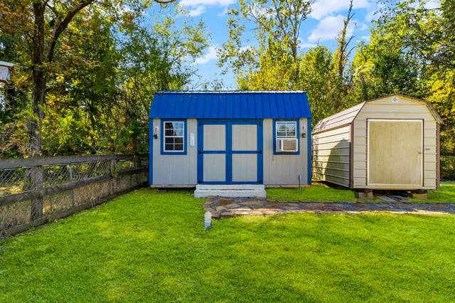 a backyard of a house with table and chairs