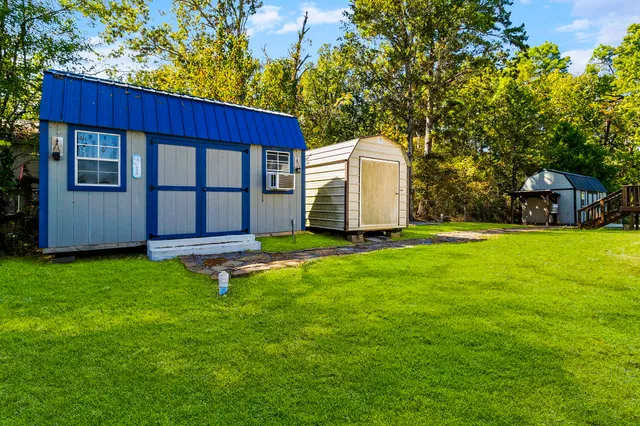 view of a house with a yard and sitting area