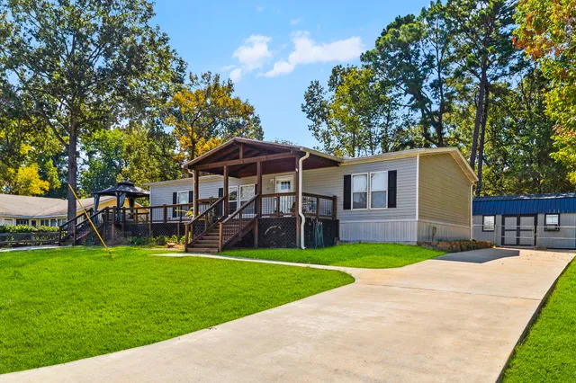 a view of a house with a yard and sitting area