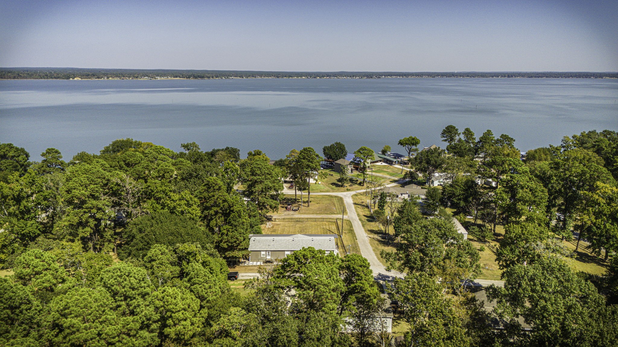 41 Ferguson Way Point Blank, TX 77364 - Photo 34 of 34 a view of a lake with a building in the background