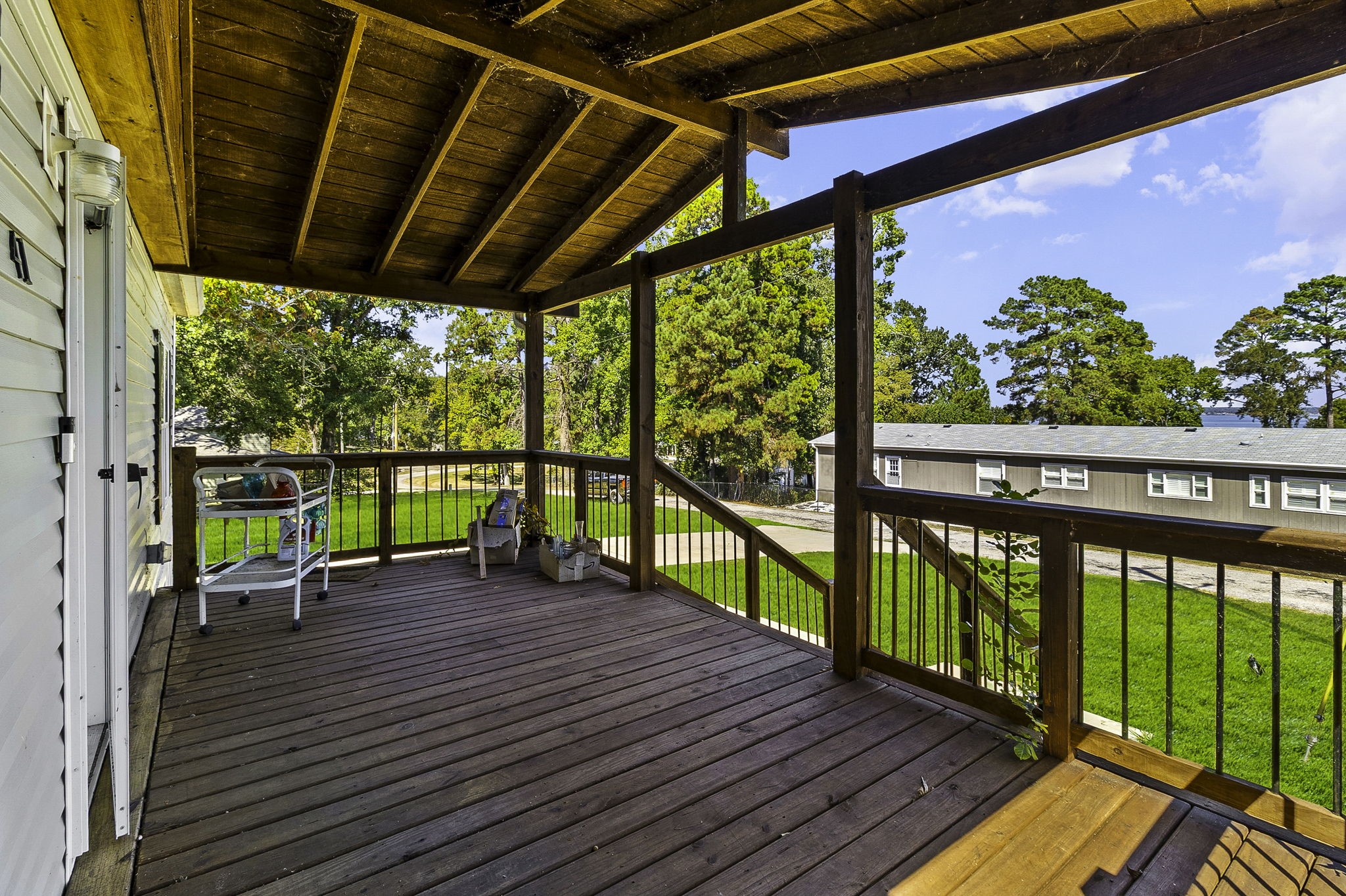 41 Ferguson Way Point Blank, TX 77364 - Photo 6 of 34 a view of a deck with wooden floor and fence with a garden view