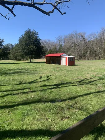 a view of a house with backyard and garden