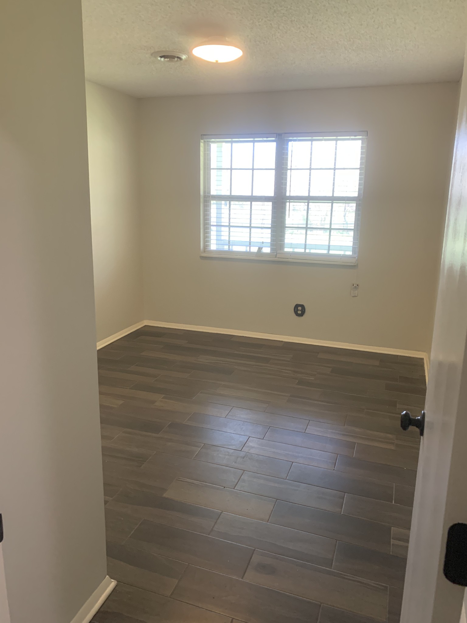 146 Cheatham Road Ardmore, TN 38449 - Photo 9 of 53 an empty room with wooden floor and windows