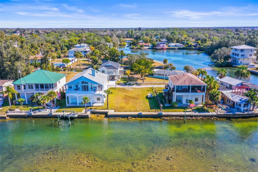 Mcdonald Lane Hudson, FL 34667 - Photo 2 of 17 an aerial view of a house with a garden and lake view