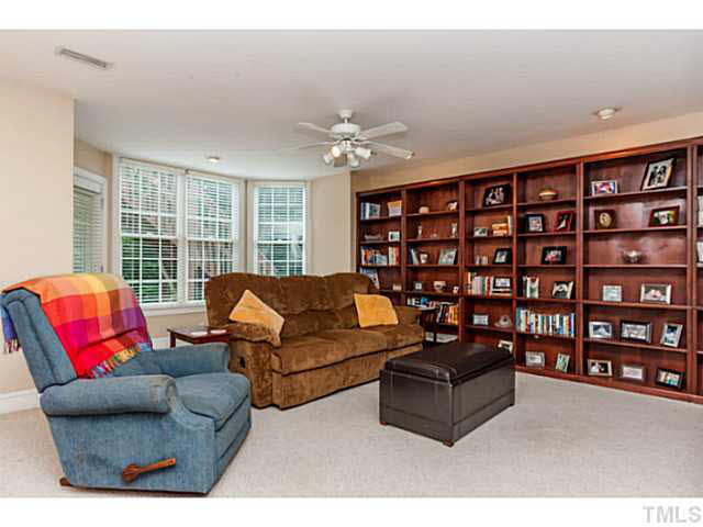 12308 Galway Drive Raleigh, NC 27613 - Photo 21 of 25 This is the large lower recreation room with a wall of built in bookcases & access the lower patio for added outdoor space!