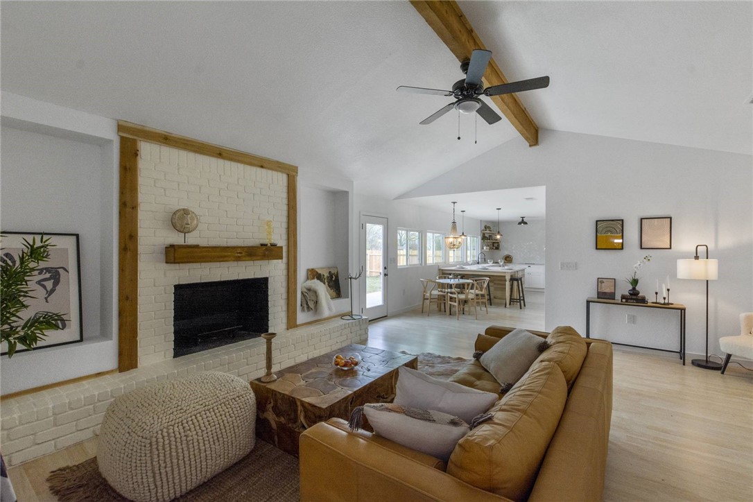 15107 Spring Hill Lane Pflugerville, TX 78660 - Photo 1 of 1 a living room with furniture and a fireplace