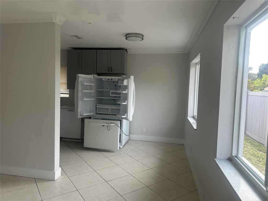 6109 Southwest 30th Street, Unit 4 Miramar, FL 33023 - Photo 6 of 16 a kitchen with a stove top oven and cabinets