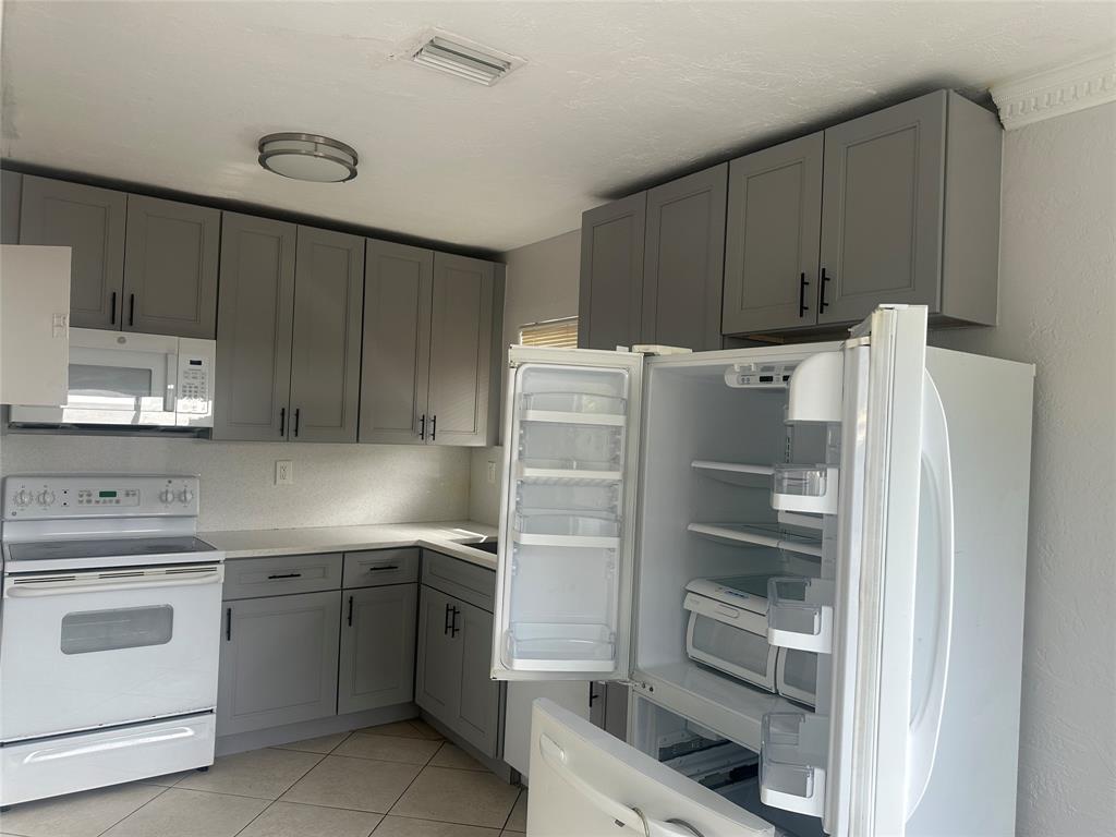 6109 Southwest 30th Street, Unit 4 Miramar, FL 33023 - Photo 9 of 16 a kitchen with a cabinets and white appliances