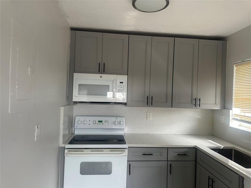 6109 Southwest 30th Street, Unit 4 Miramar, FL 33023 - Photo 10 of 16 a kitchen with a cabinets and white stove